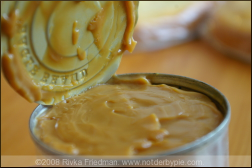 Peel the label of the can of sweetened condensed milk. Do not open the can. Peel the label of the can of sweetened condensed milk. Do not open the can.