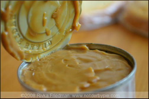 Peel the label of the can of sweetened condensed milk. Do not open the can.